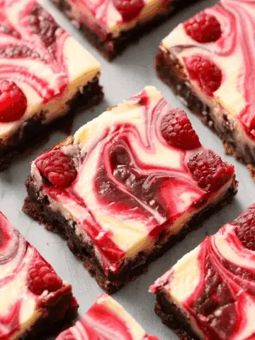 Decadent Raspberry Swirled Brownie Cheesecake Bars